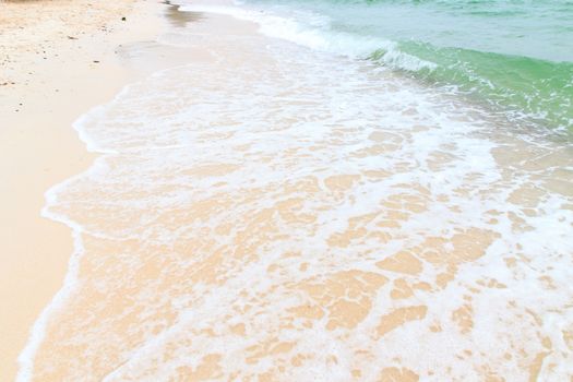 Soft wave of the sea on the sandy beach.