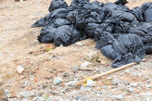 A pile of the black garbage bags waiting for a disposal.