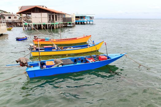 Small boats for fishing and water beautiful colors.