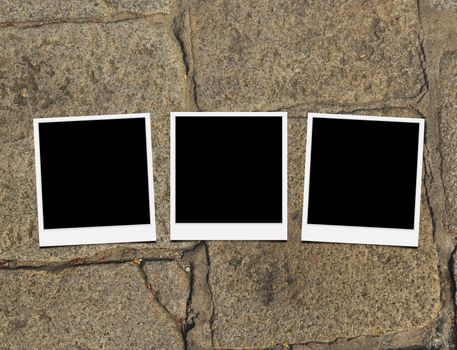 Blank instant photo frames on old brick floor and small cracks. 