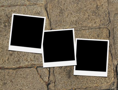 Blank instant photo frames on old brick floor and small cracks. 