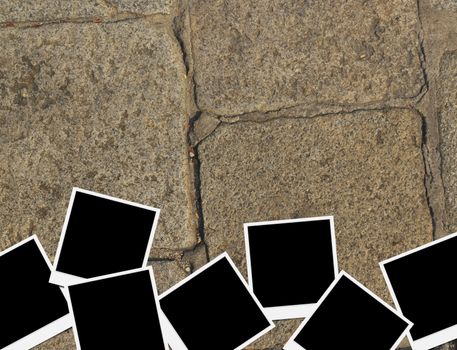 Blank instant photo frames on old brick floor and small cracks. 