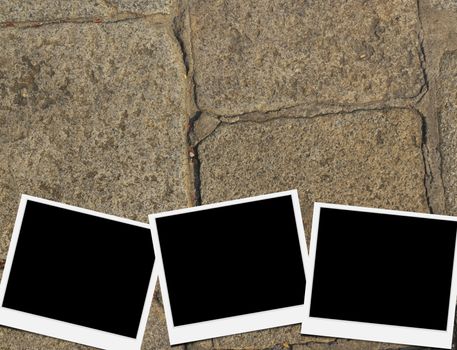 Blank instant photo frames on old brick floor and small cracks. 