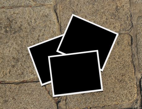 Blank instant photo frames on old brick floor and small cracks. 