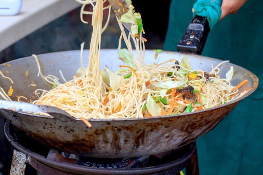 Stir-fried chow mein noodles  in a pan.