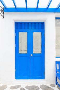 Blue elegant entrance door with white wall.