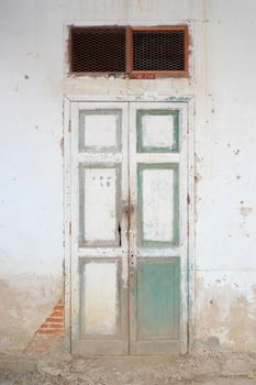 Old Blue retro door with grunge wall.