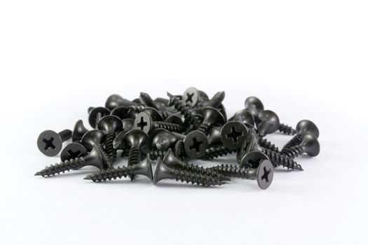 Black drywall screws isolated on white background. 