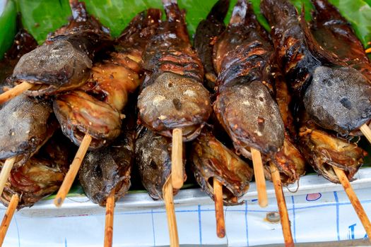 Grilled fish thai style with a wooden plug.