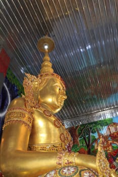 Statue of golden guardian at church of tainless steel temple, thailand.