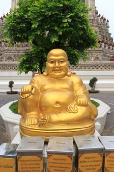 Happy buddha statue at Wat Arun in bangkok, thailand.