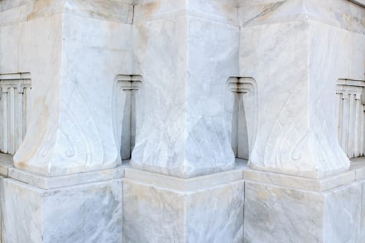 The pole carved out of marble with an artistic pattern.