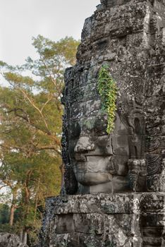 Smiling Buddha or king stone face in ancient Bayon wat temple, Angkor area, Cambodia