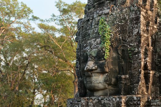Smiling Buddha or king stone face in ancient Bayon wat temple, Angkor area, Cambodia