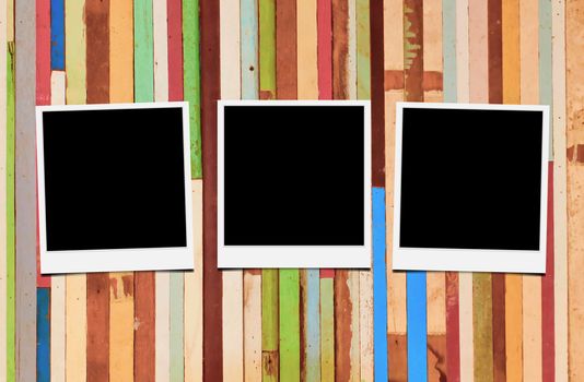 Blank instant photo frames on wooden background. 