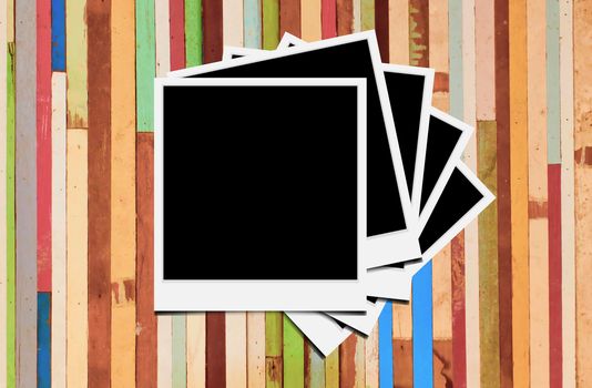 Blank instant photo frames on wooden background. 
