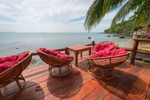 Relaxing lounge chair relax area in beach cafe by the blue sea