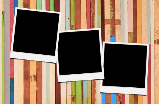 Blank instant photo frames on wooden background. 