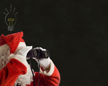 Father Christmas looking at the future business strategy idea with binoculars on backboard background