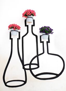 collage with geranium flowers in planters on the wall.