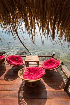 Relaxing lounge chair relax area in beach cafe by the blue sea