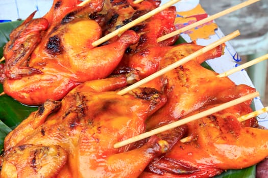Grilled chicken thai style with a wooden plug.