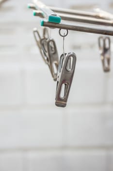 Aluminum clothespin hanging on the hanger