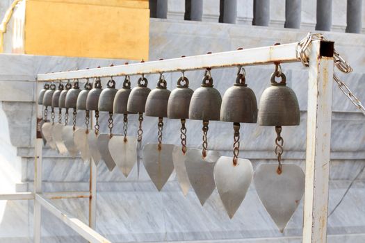 Lots of small bells hanging in the thai church.