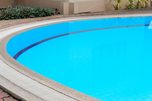 Outdoor in ground residential swimming pool in backyard.