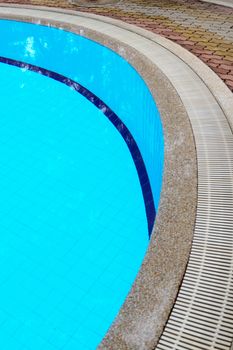 Outdoor in ground residential swimming pool in backyard.