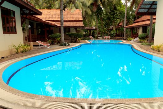 Outdoor in ground residential swimming pool in backyard.