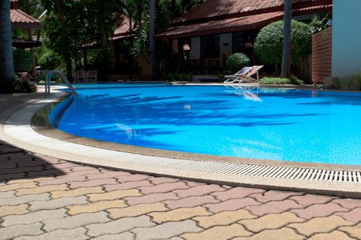 Outdoor in ground residential swimming pool in backyard.