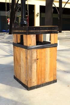 A wooden public trash in the shopping center.
