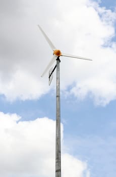 Wind turbine under a blue sky from Lumpini park in bangkok.