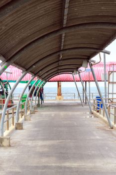 Walkway to the the dock with a roof.