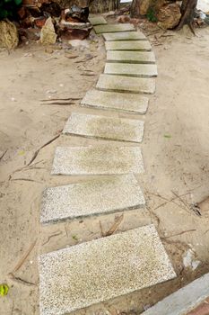 Walkwalk made of bricks in various colors at the beach.