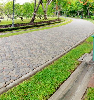 Walkwalk made of bricks in various colors at garden.
