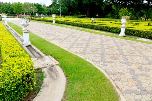 Walkwalk made of bricks in various colors at garden.