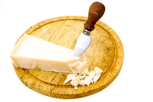 Parmesan cheese on cutting board with knife on white background