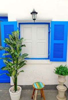 Blue window with white wall of shopping center.