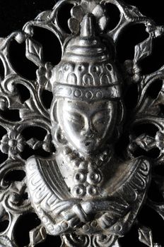 Silver Buddha Pendant Jewel over a Black Background