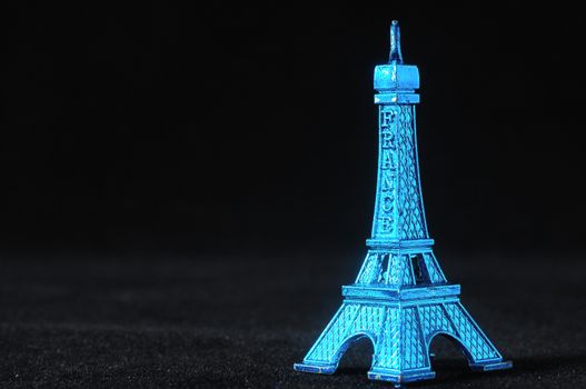 Blue Tour Eiffel Statuette on a Black Background
