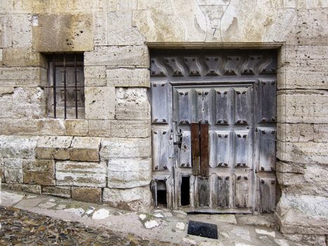 Abandoned manor door and window in a Spanish small town.