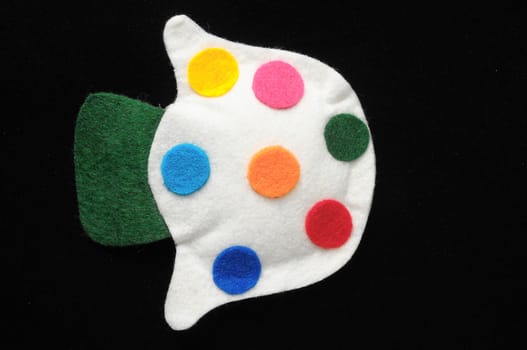 Cloth Multicolored Magic Mushroom on a Black Background