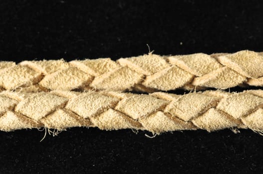 Brown Textured Braided Leather Necklace on a Black Background