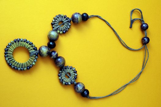 Handmade Wood Collar Necklace on a Colored Background