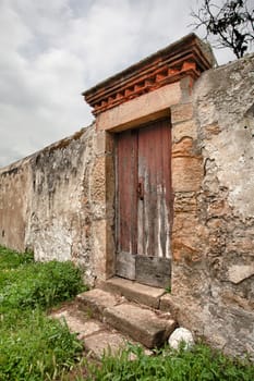 Abandoned door on a wall with stairs