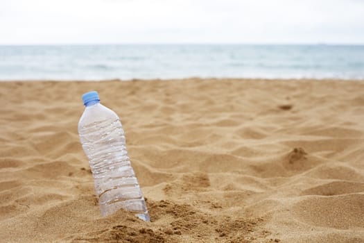 Plastic Bottle Abandoned on the Beach Sand