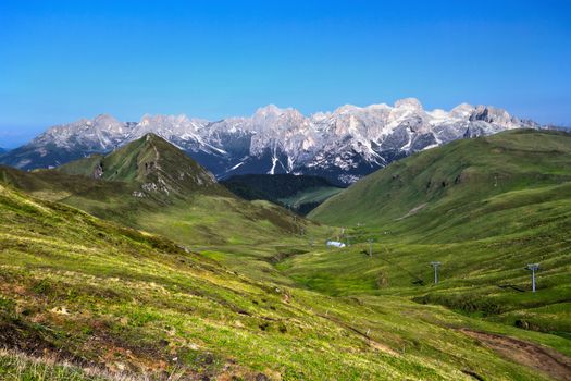 summer landscape in Fassa Valley with Catinaccio group on background, Trentino, Italy