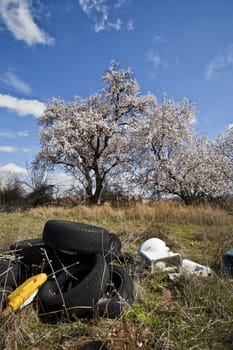 Landfill with tires and trees in spring